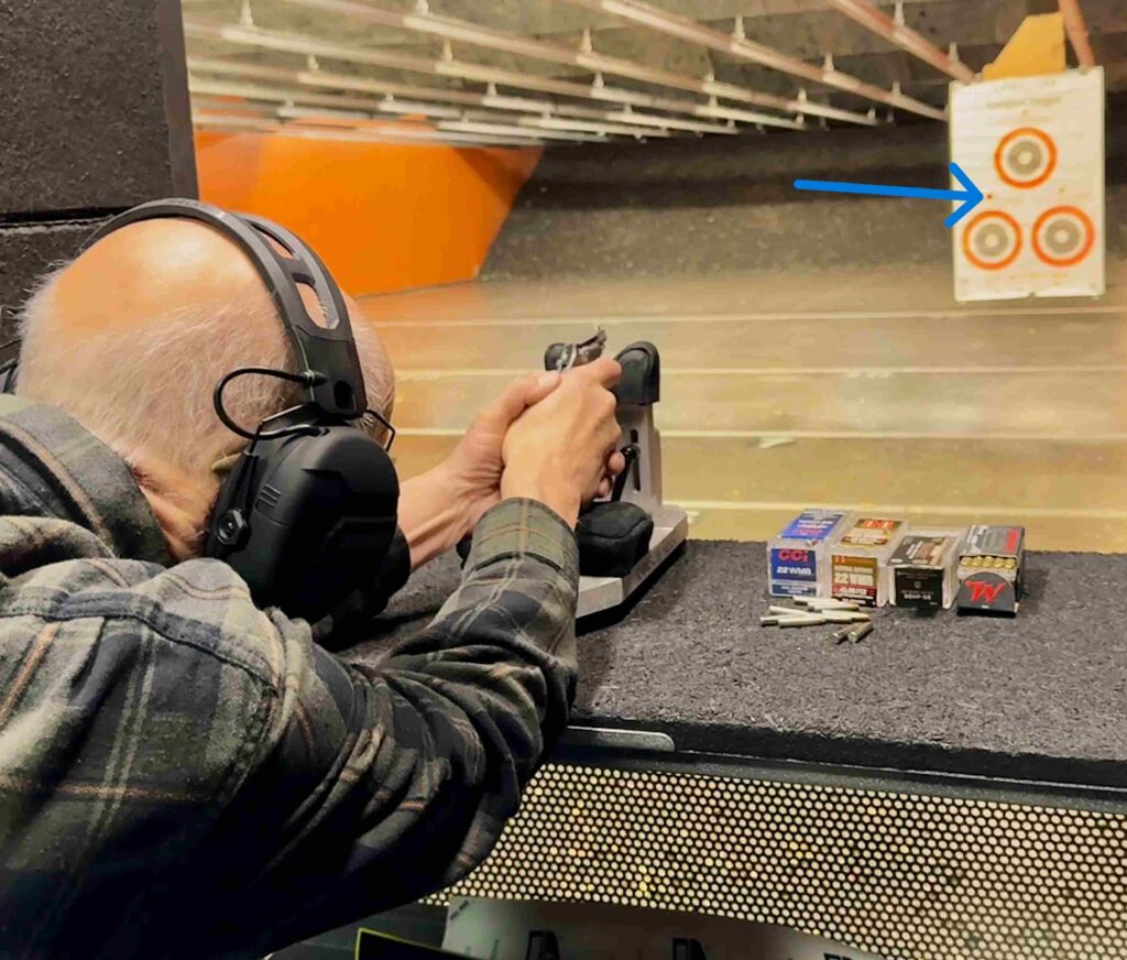 Photo of author shooting gun in seated position