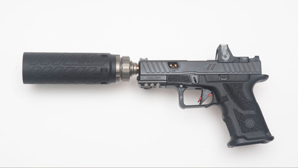 Photo of the Neilson Device with mounted can on a handgun 