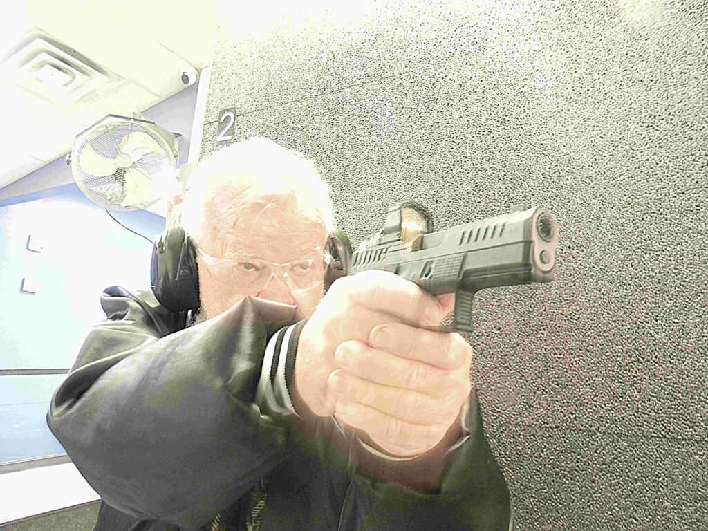 Photo of author shooting the handgun inside a range