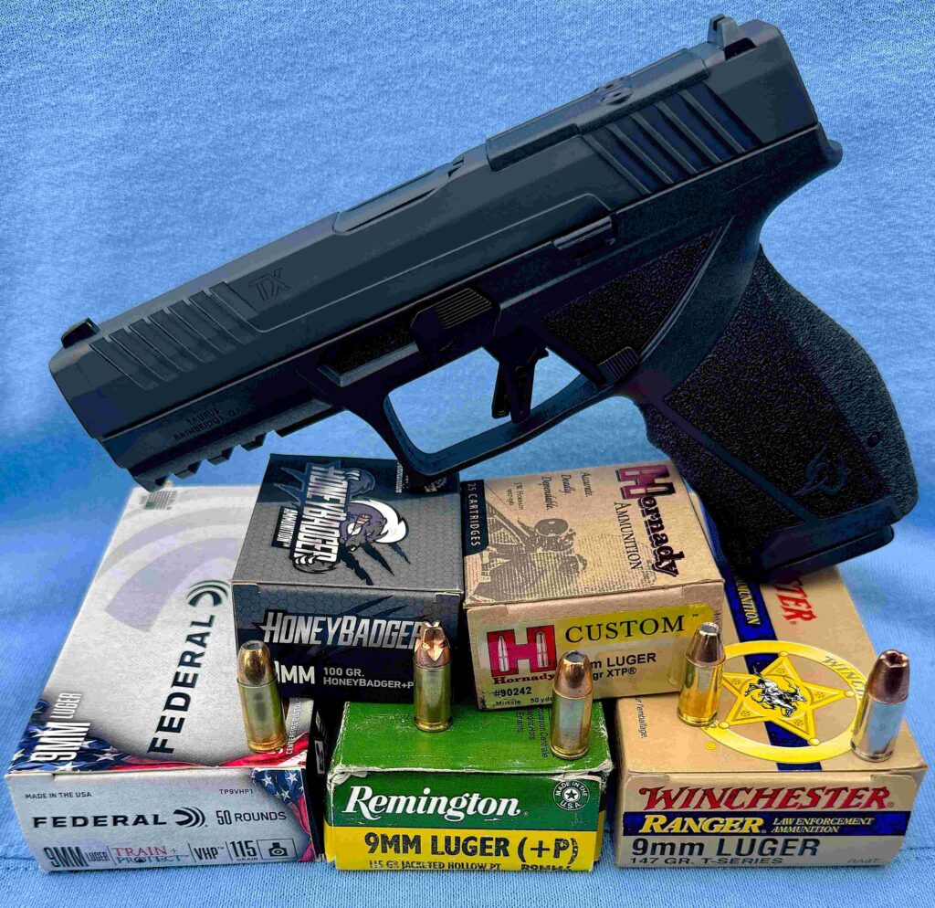 Photo of gun on top of the 5 various ammo used for testing