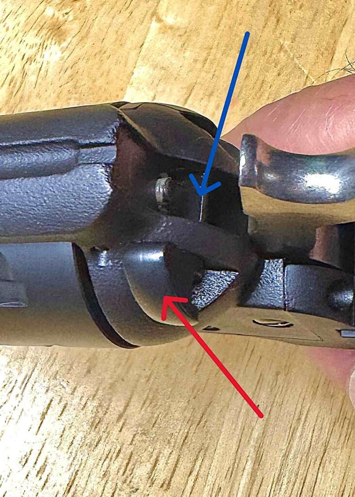 arrow pointing to the rear sight and cylinder of the firearm 
