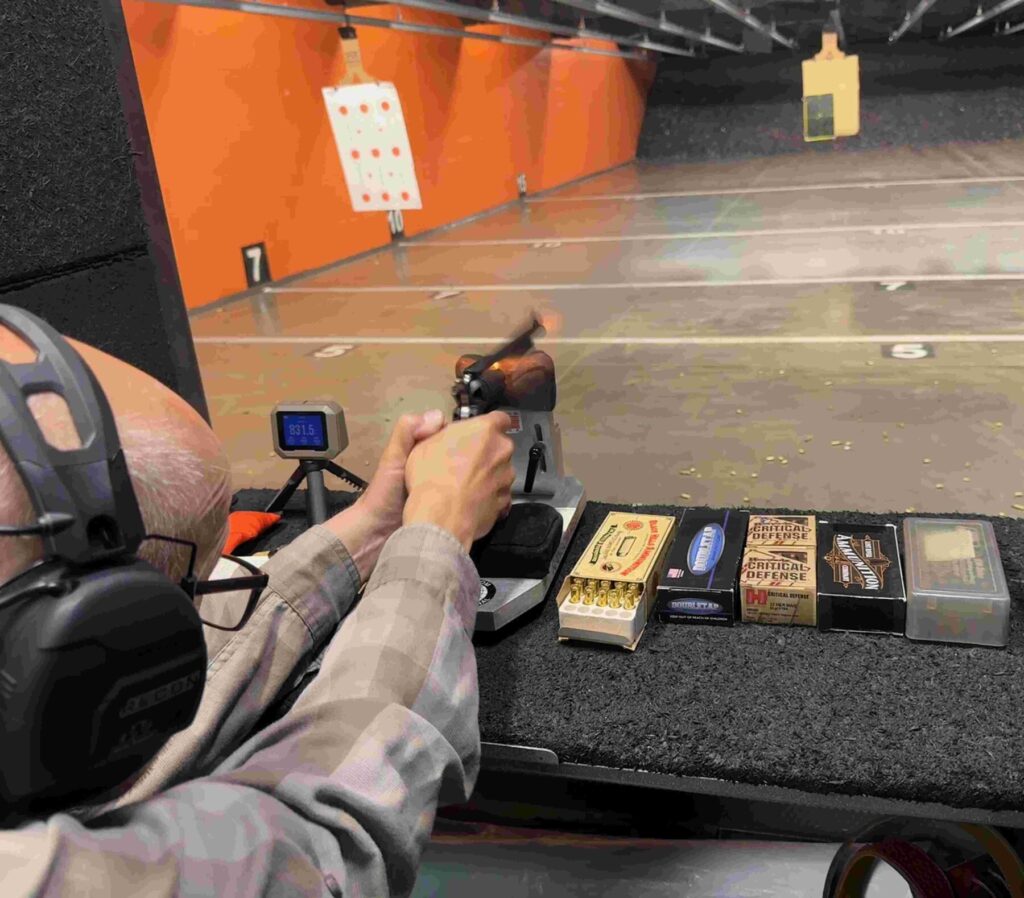 author shooting the gun seated 