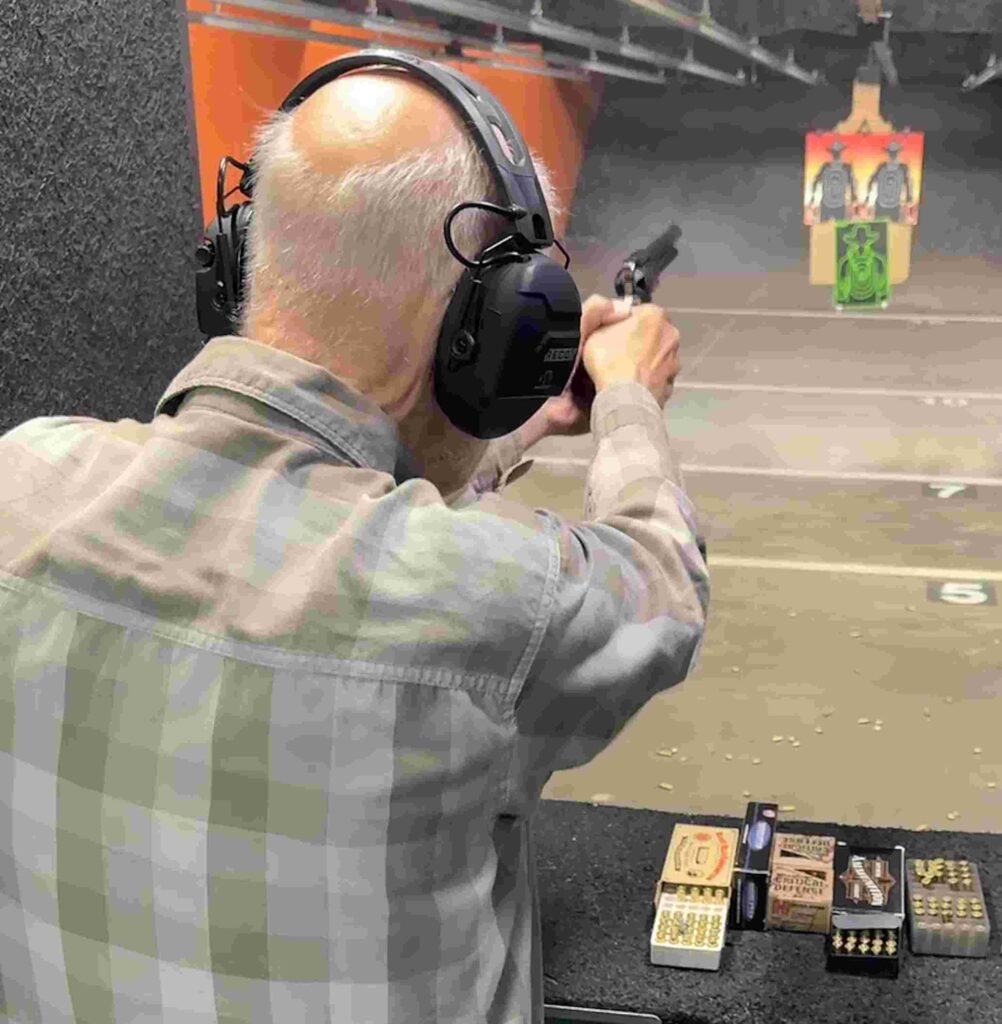author shooting the gun standing 
